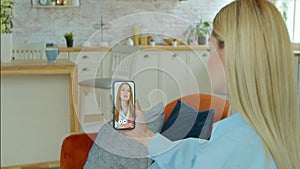 Woman checks possible symptoms with professional physician, using online video chat. Young girl sick at home using