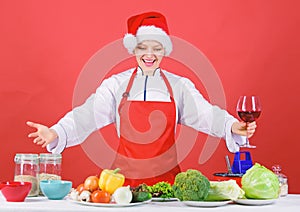 Woman chef or housewife cooking and drink wine. No stress. Best christmas recipes. Enjoy easy ideas for winter party and