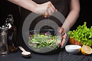 Woman chef in the kitchen preparing vegetable salad. Healthy Eating. Diet Concept. A Healthy Way Of Life. To Cook At