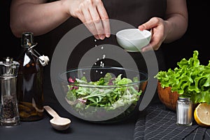 Woman chef in the kitchen preparing vegetable salad. Healthy Eating. Diet Concept. A Healthy Way Of Life. To Cook At