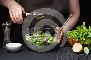 Woman chef in the kitchen preparing vegetable salad. Healthy Eating. Diet Concept. A Healthy Way Of Life. To Cook At Home. The gir