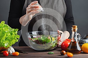 Woman chef in the kitchen preparing vegetable salad. Healthy Eating. Diet Concept. A Healthy Way Of Life. To Cook At Home. For