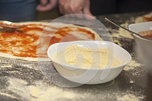 Woman chef with raw dough.