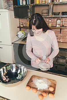 Woman Chef sifts flour, knead the dough. Bakery or Baking Concept. Ingredients for dough