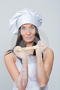 woman in chef uniform knead the dough