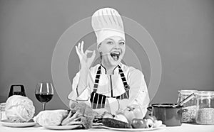 Woman chef wear hat apron near table ingredients. Girl adorable chef teach culinary. Best culinary recipes to try at