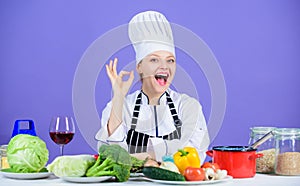 Woman chef wear hat apron near table ingredients. Girl adorable chef teach culinary. Best culinary recipes to try at