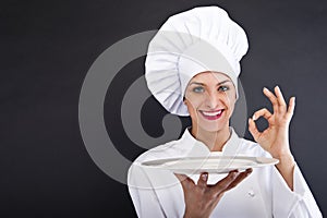 Woman cheff over dark backgrund photo