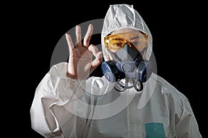 Woman in chemical protective clothing and antigas mask with glasses at white background, Women scientist in safety suit, Safety