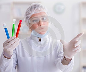 Woman chemist pressing virtual button in lab