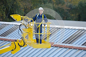 Woman in cherry picker bucket