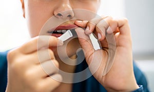 Woman Chewing Wet Moist Nicotine Product photo