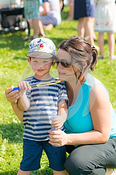 Woman and child blowing soap bubbles