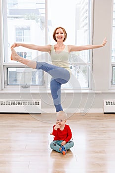 Woman with child boy son doing workout in gym class to loose baby weight.