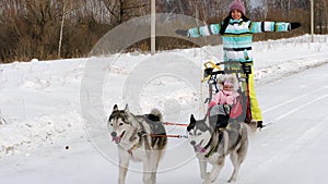 Woman and child in dog sled