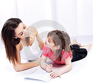 Woman and child drawing on notepad