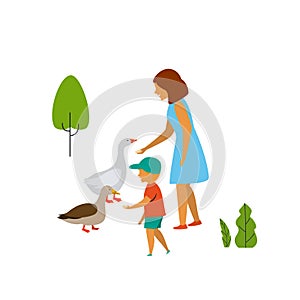 Woman and child feeding birds in the park