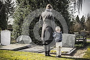 Woman and child at graveyard