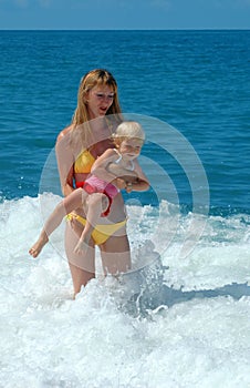 Woman and child have fun in sea