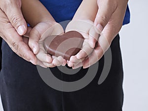 Woman and child holding chocolate heart