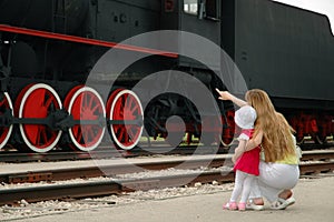 Woman and child look at locomotive