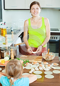 Woman with a child making fish dumplings freshest salmon stuffi