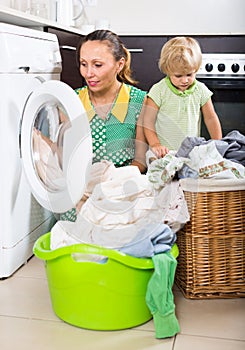 Woman with child near washing machine