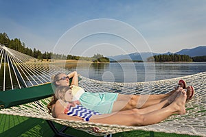 Woman and child relaxing in a hammock on a beautiful Mountain Lake