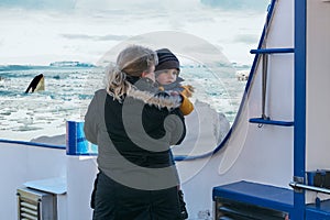 Woman with child on a ship during a polar trip.