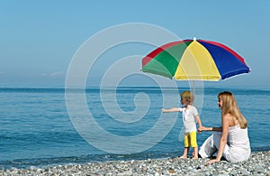 Woman with child under umbrella