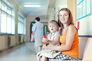 Woman and child with urinalysis sample photo