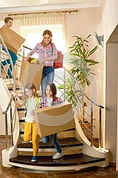 Woman and children carrying boxes.