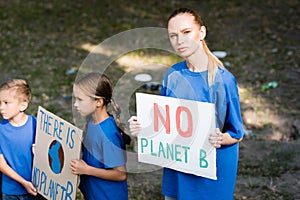 Woman and children holding placards with