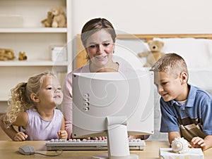 Woman and Children Playing on Computer