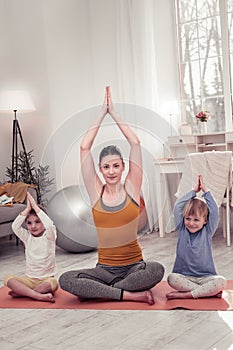 Woman and children sitting in pranayama pose