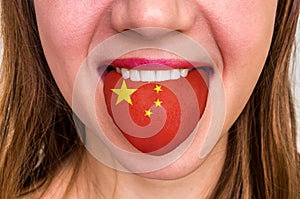 Woman with chinese flag on the tongue