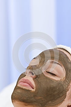 Woman In Chocolate Face Mask Facial At Health Spa