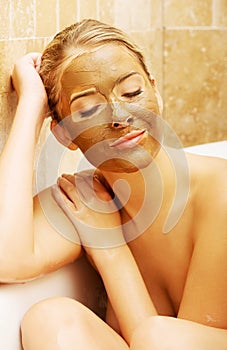 Woman with chocolate mask based on a bath by elbow