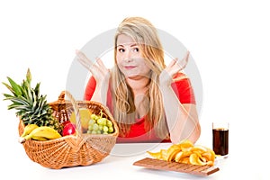 Woman with choice of healthy and junk food