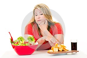 Woman with choice of salad bowl and junk food