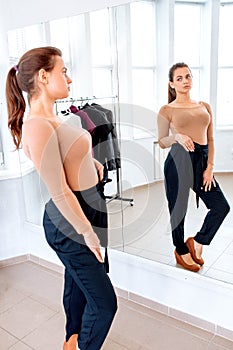 Woman chooses clothes on a hanger