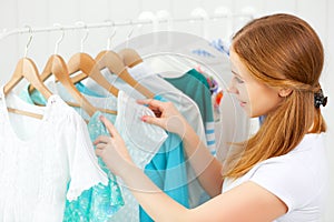 Woman chooses clothes in her wardrobe