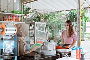 Woman chooses food in menu