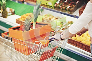 A woman chooses fresh food in a supermarket
