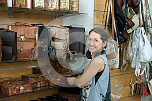 Woman chooses leather chest at shop