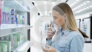 Woman chooses perfume in the store