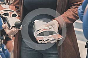 Woman chooses to buy gloves for a mixfight. Hands close up shot
