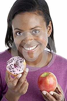 Woman Choosing Between Apple And Doughnut