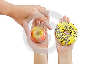 Woman choosing between apple or junk food, donut. Diet and healthy food concept. Vegetarian, vegan, raw concepts. Apple and donut