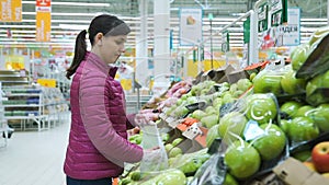 Woman Choosing Apples at the Supermarket